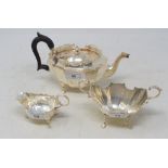 A silver three piece tea service, of shaped rectangular form, various dates and makers, approx. 16.9