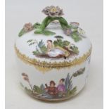 A Meissen porcelain bowl and cover, decorated figures, and with a floral encrusted handle, 12 cm