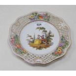 A late 19th century Dresden plate, the centre decorated figures, within a rococo and pierced border,