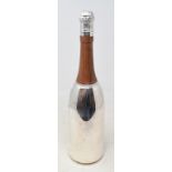 A plated cocktail shaker, in the form of a champagne bottle Modern