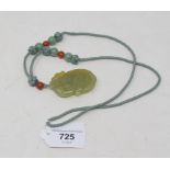 A Chinese carved and pierced jade pendant, in the form of a mythical animal on a fruit, the