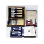 EXTRA LOT: Four silver napkin rings, boxed, a set of six silver teaspoons and sugar tongs, boxed and