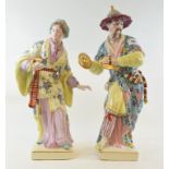 A porcelain figure, of a musician, 41 cm high, and his companion (2) Modern