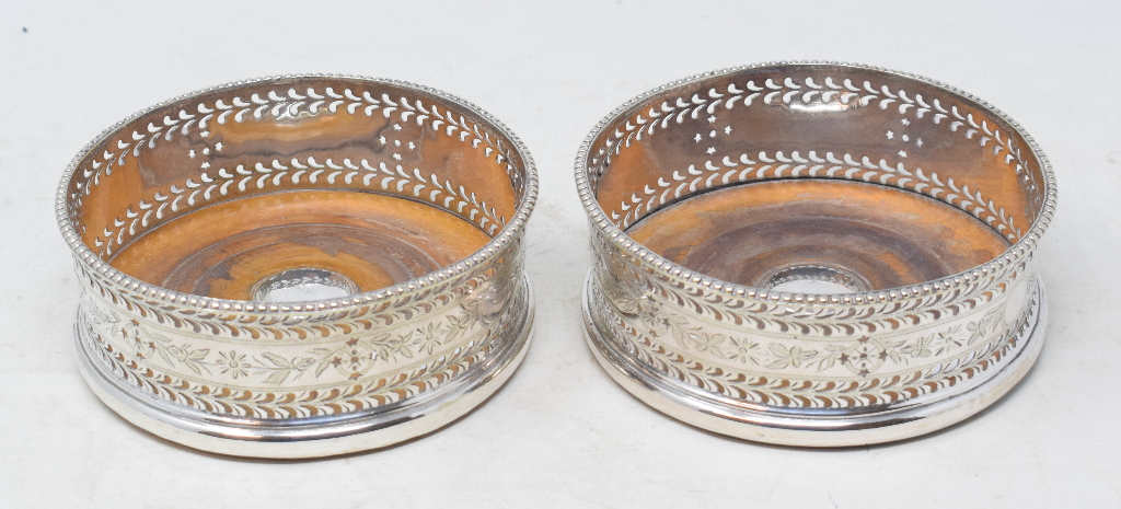 A pair of Victorian silver plated wine coasters, with pierced and engraved decoration (2)