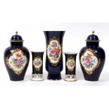 A garniture of five Meissen porcelain vases, decorated floral sprays on a blue ground, comprising