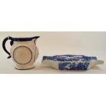 A 19th century stoneware jug, decorated face masks, 13 cm high, and a blue and white pottery