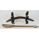 An Aboriginal carved hardwood boomerang, 61 cm, a large carved hardwood tribal spoon, and two carved