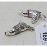 Two silver novelty horse head whistles