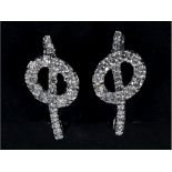 A pair of white gold and diamond earrings, in the form of musical notes See illustration