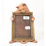 A painted bronze cat strut photograph frame, 25 cm high