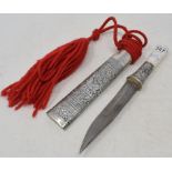 A Malaysian style dagger, the scabbard with silver coloured metal mounts, probably early 20th