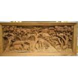 An African carved wood panel, decorated a safari scene with elephants and other animals by a