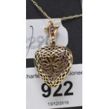 A 9ct gold, ruby and diamond heart locket, on a 9ct gold chain