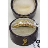 A yellow coloured metal and five stone diamond ring, approx ring size P, apparently unmarked, and