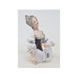 A Muller porcelain half doll, lady with grey hair, wearing a purple and white dress with garlands of