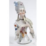 A porcelain half doll, probably Goebel, lady with elaborate grey hair and a white dress with