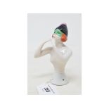 A porcelain half doll, probably Goebel, nude lady wearing a black cap and a green eye mask,