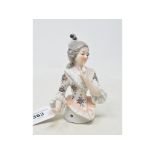 A porcelain half doll, probably Galluba & Hoffman, lady with grey hair and a white dress, with