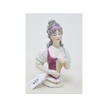 A Dressel & Kister porcelain half doll, girl with grey ringlets and a purple dress, holding a fan,