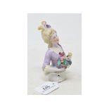 A porcelain half doll, lady with light coloured hair with three feathers and wearing a lilac