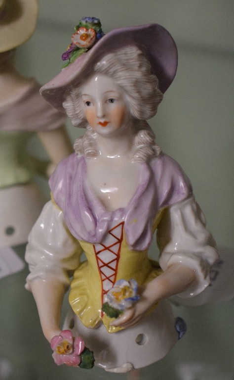 A porcelain half doll, lavender hat and scarf, holding flowers and wearing a yellow corset, 12 cm - Image 4 of 5