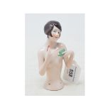 A Hertwig & Co porcelain half doll, nude lady with black bob hair, applying lipstick, 12 cm high