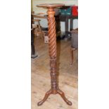A Victorian mahogany torchere, with a rope twist and lotus leaf carved column, on a tripod base