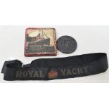 A Lusitania medallion, boxed, and an early 20th century Royal Yacht cap tally (2)