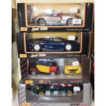 A Maisto 1:18 die-cast model Porsche 911 GT1, and three others, all boxed (4)