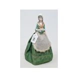 A Galluba & Hoffman porcelain half doll, the chocolatier lady, wearing a green fabric dress, 25 cm