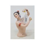 A porcelain half doll, nude Spanish dancer, arms raised holding castanets, 13.5 cm high