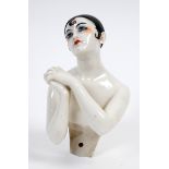 A Dressel & Kister porcelain half doll, nude Pierrot, arms forward with hands clasped, 12 cm high