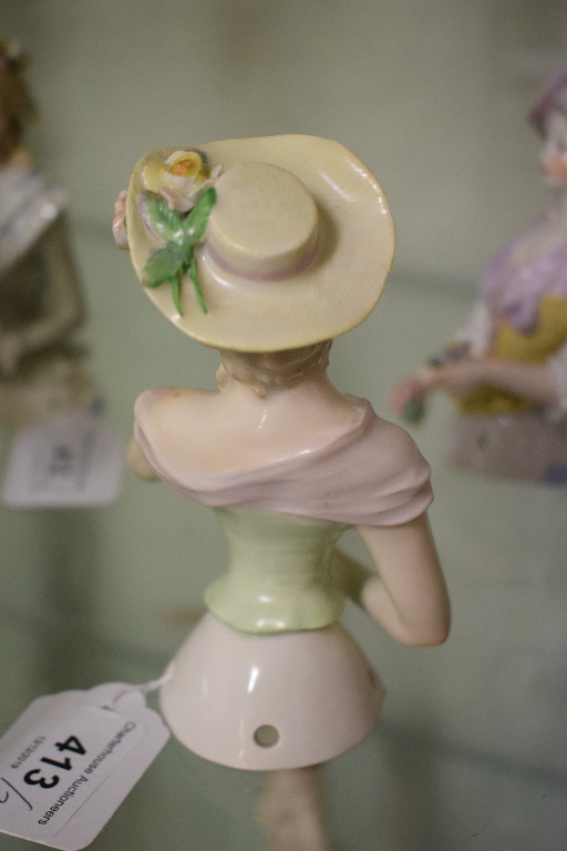 A porcelain half doll, lavender hat and scarf, holding flowers and wearing a yellow corset, 12 cm - Image 3 of 5