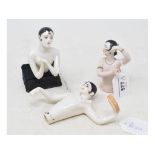 A porcelain half doll, nude Pierrot, 9 cm high, and two others similar (3)