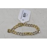 An 18ct gold and diamond curb link bracelet Report Weight - 34.8 g