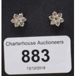 A pair of diamond flowerhead cluster stud earrings, approx. 1.00ct, boxed