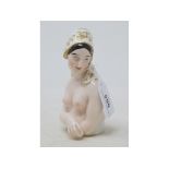 A porcelain half doll, French nude with medieval style headscarf, printed mark France to back, 13 cm