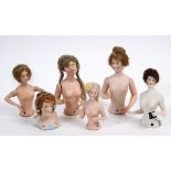 A bisque half doll, nude lady with wig and moving arms, impressed no. 3593 under a heart to back, 12