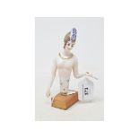 A Dressel & Kister porcelain half doll, nude lady with medieval style beaded cap and gold