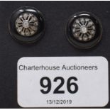 A large pair of stud earrings, set diamonds within a surround of black enamel, boxed