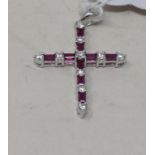 An 18ct white gold, ruby and diamond set cross, the rubies approx. 0.31ct, the diamonds approx. 0.