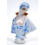 An Art Deco porcelain half doll, lady with a blue stripped cap and matching dress, impressed no.