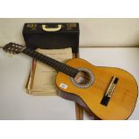 A Boosey & Hawkes clarinet, cased, a guitar and some sheet music (qty)