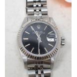 A lady's stainless steel Rolex Oyster Perpetual Date wristwatch, with black dial, baton indices