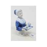 A Goebel porcelain half doll, lady serving tea on a tray, decorated in underglaze blue, impressed