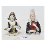 A porcelain half doll, Dutch lady wearing a black corset and a gold hat, 9 cm high, and another (2)