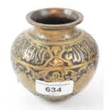 An Islamic brass vessel, of compressed baluster form, decorated foliage and calligraphy, 9 cm high