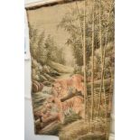 A Japanese needlework hanging, decorated a landscape of buildings and trees, 120 cm wide, and