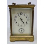 A brass carriage clock, with Arabic numerals, striking on a gong, 14.5 cm high