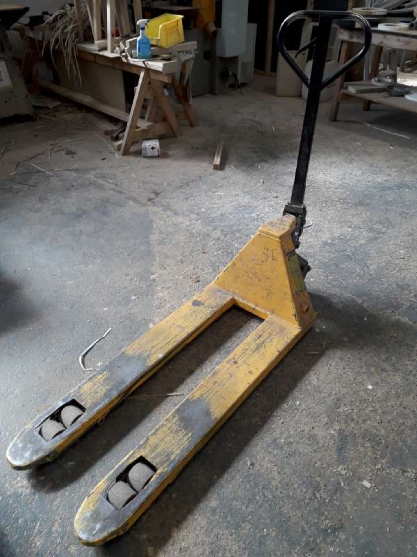 YELLOW PAINTED PALLET TRUCK.